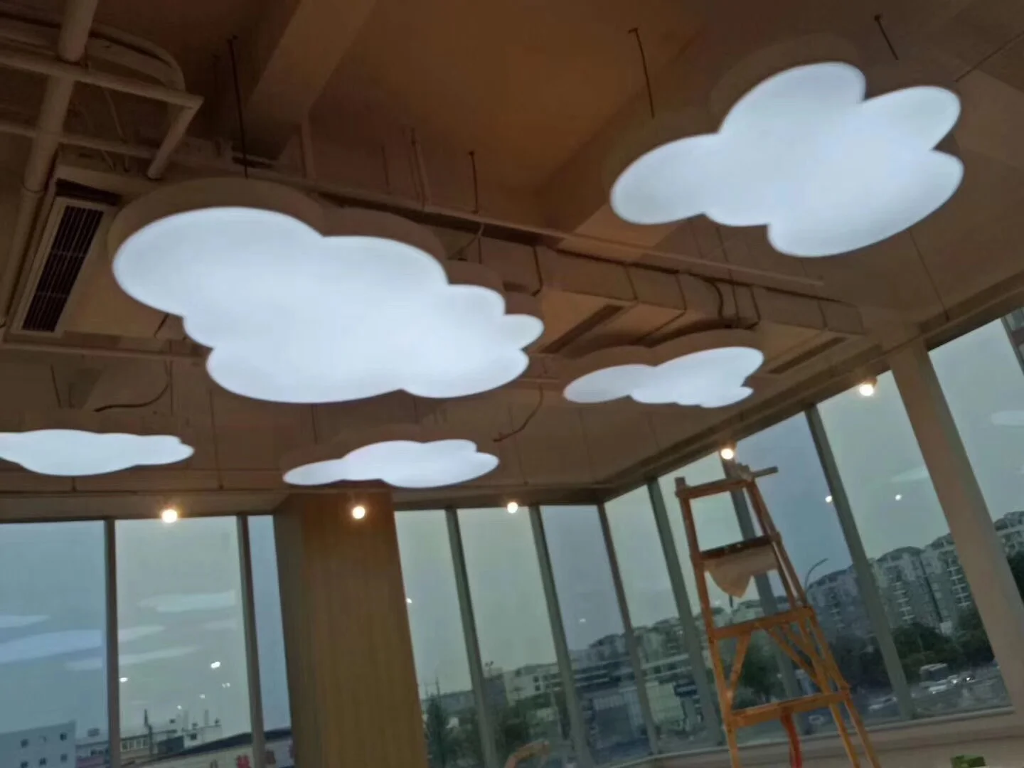 Applications & Prototypes Cloud-shaped illuminated ceiling forms installed in an interior space