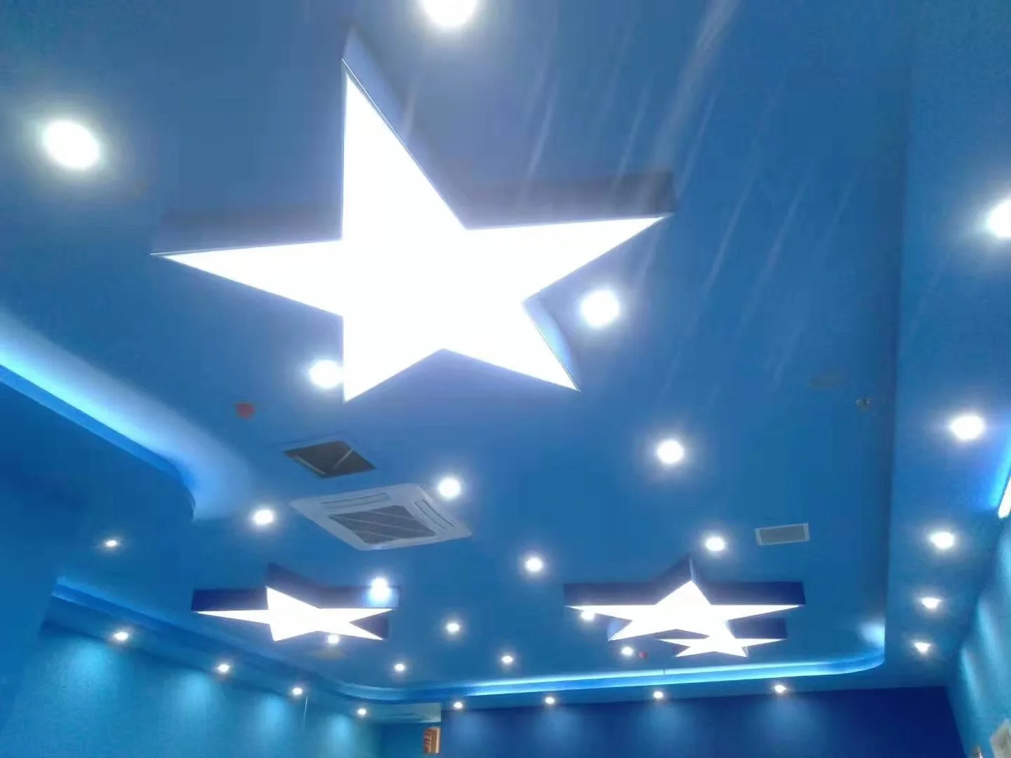 Applications & Prototypes Star-shaped illuminated ceiling forms installed in a blue interior