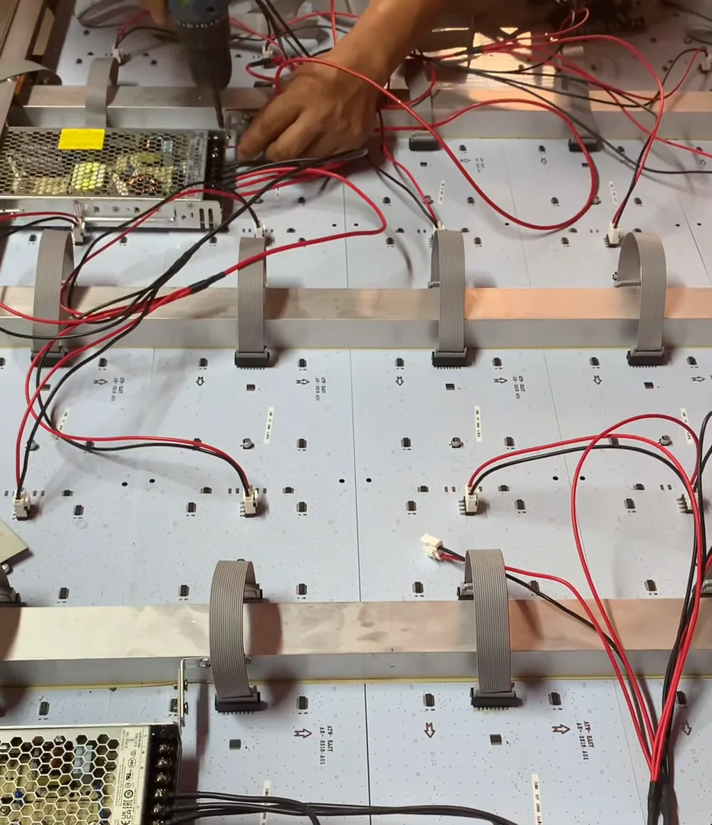 Open display enclosure with LED boards, wiring and power components during assembly