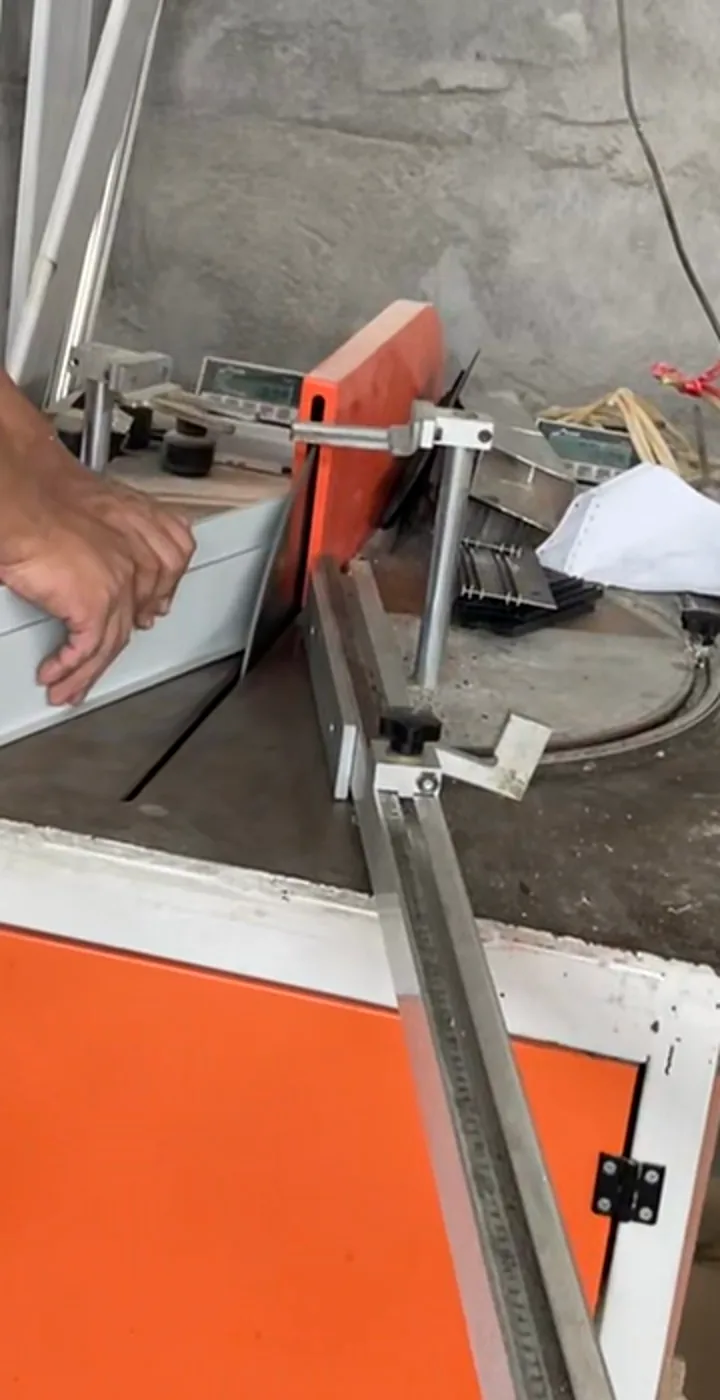 Profile section positioned at a cutting jig during processing