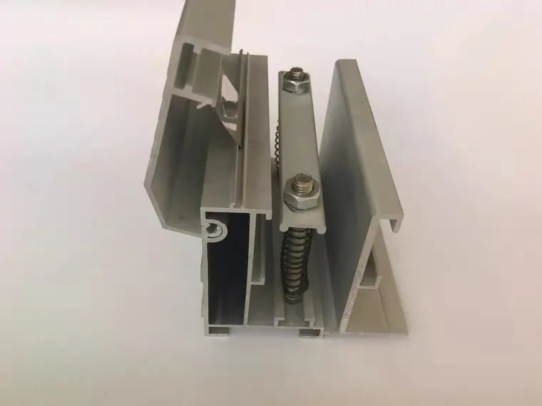 Spring-tensioning hardware inside a fabric light box profile